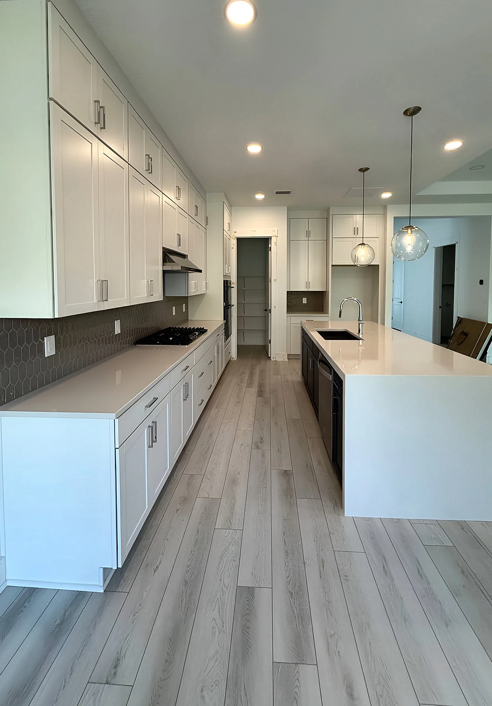 White Galley Kitchen with Waterfall Island — Panama City Beach