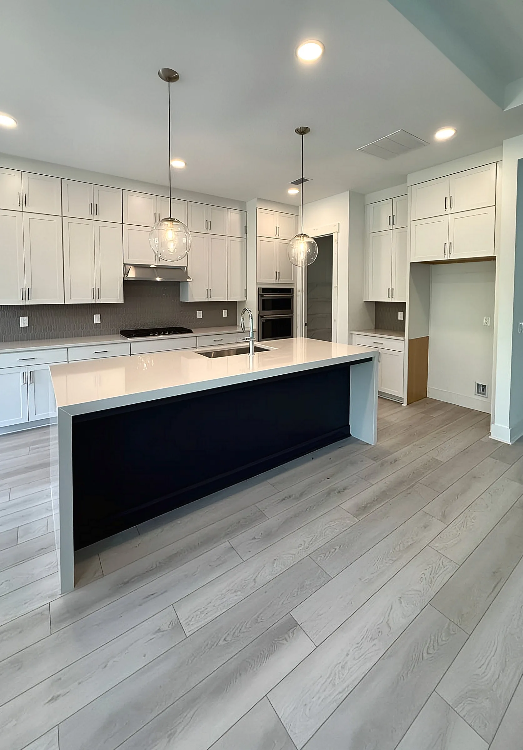 White Kitchen with Dark Waterfall Island — Panama City Beach